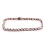 A diamond line bracelet in 9ct white gold, comprising a single row of brilliant-cut diamonds,
