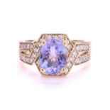 A tanzanite and diamond dress ring, centrally set with oval faceted tanzanite with a light bluish-