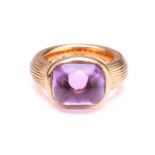 An amethyst dress ring in 18ct yellow gold, comprising a rectangular buff-top amethyst with a