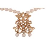 A pearl necklace with a diamond-set pendant, the axe-shaped pendant comprises intricated foliate and