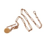 A 9ct gold Albert chain with coin charm, the figaro link chain is terminated with a swivel clasp and
