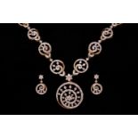 A diamond-set necklace and earrings suite, of swirl designs; the necklace comprises a circular motif