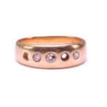 An 18ct gold ring set with diamonds, comprising a plain band and later-added gemstones, graduated