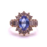 A tanzanite and diamond cluster ring and a pair of matching earrings; the ring comprises an oval