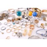 A quantity of assorted base metal costume jewellery comprising various hinged bangles, line
