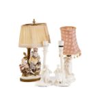 A pair of Continental white glazed porcelain figural table lamps one with a young gentleman and