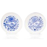 A pair of Chinese porcelain blue & white 'Dragon' dishes, painted with a writhing dragon chasing a