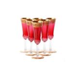 A set of six Saint-Louis red crystal glass thistle design champagne flutes, sealed in the original