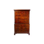 A George III satinwood cross-banded secretaire chest on chest. The upper carcass with canted and