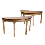 A pair of George III style demi lune console tables,19th century and later, the figured ash tops