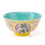 A Chinese porcelain bowl, painted with roundels of cranes and peaches, bordered by lotus flowers and