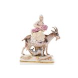 A Meissen figure of the Welsh Tailor`s wife riding a goat, the baby and kid feeding from their