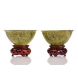 A pair of Eastern circular variegated moss green jade bowls with slightly everted rims each on