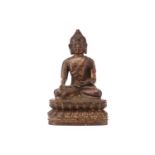 A patinated and gilt bronze figure of a Tibetan-style Buddha seated in dhyansana mudra upon a double