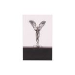A Rolls Royce "Spirit of Ecstacy" mascot paperweight, encased in a two-tone lucite block, 11.5 cm