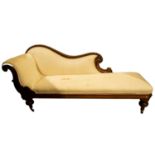 A Victorian single-ended mahogany chaise lounge with scroll end and serpentine back rest with