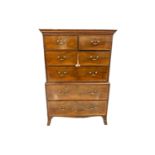 A George III mahogany chest on chest with satinwood banded cornice with patera detail. The upper