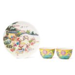 A pair of Chinese porcelain tea bowls, the exterior painted with lotus flowers and leaves against