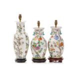 A pair of Chinese Famile rose porcelain baluster vase form table lamps, 20th century, painted with