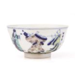 A Chinese porcelain wucai bowl, painted with the eight immortals, above a band of waves,