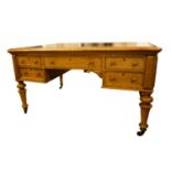 A Victorian birdseye maple partners kneehole library, writing table with tooled hide inset top