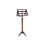 An early 19th century mahogany Continental duet stand, with articulated candle arms and rise and