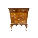 A George II walnut chest on later stand, the upper section with two short over three long drawers,