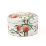 A Chinese Yongzheng-style circular Famile Rose porcelain lidded box with a slightly domed cover