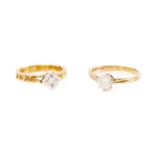 Two diamond solitaire rings in 18ct yellow gold; the first contains a circular-cut diamond of 5.7