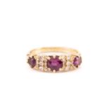 A late Victorian ruby and diamond half-hoop ring; the three graduated circular cut rubies set