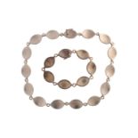 Georg Jensen - A necklace and bracelet suite, with navette-shaped and concave links, connected to