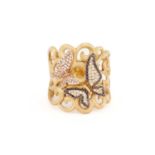 A diamond butterfly design dress ring, the satin finish yellow gold scrollwork mount accented with