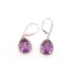 A pair of amethyst and cubic zirconia pendant earrings, each comprising a pear-shaped amethyst of