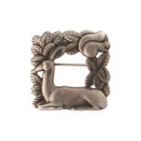 Georg Jensen - A square openwork brooch in silver, featuring a resting deer and squirrel in foliage,