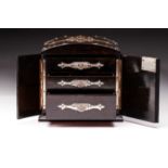 A Victorian slightly dome-topped figured coromandel dressing table jewellery chest with applied