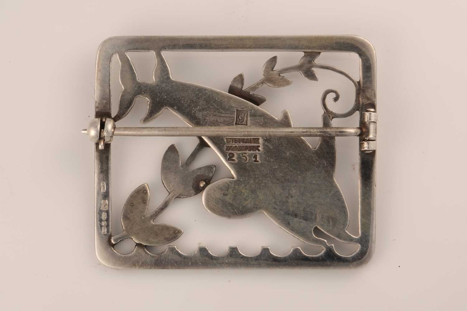 Georg Jensen - A silver 'double dolphin' brooch, depicting two dolphins with a fern motif across - Image 2 of 2
