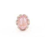 A pink tourmaline and diamond cocktail ring, featuring a high-dome pink tourmaline cabochon,