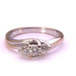 A three-stone diamond crossover ring in 18ct white gold, comprising three graduated brilliant-cut
