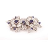 A floral duette brooch set with sapphires and diamonds, comprising two detachable flowerheads,