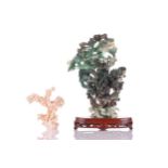 A Chinese carved and pierced variegated spinach jade study of a lidded urn and pair of writhing