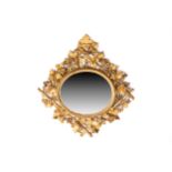 A 19th-century Florentine carved wood and gilt gesso oval wall mirror with rustic fruiting vine