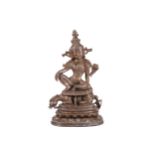 A Chinese bronze figure of Guanyin seated over a mythical beast, on a stepped base with lotus