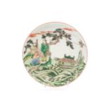 A Chinese porcelain famille verte dished plate, painted with two sages and attendant beside a pine