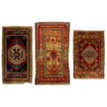 An old Turkish red ground Taspina mat with a distinctive central motif within floral borders, 1.2