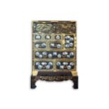 A Japanese muted brown lacquer Tansu, Meiji, early 20th century, with engraved brass corners and