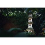 An established reconstituted stone Japanese-style six-tier garden pagoda, 20th century, with lotus