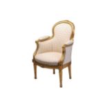 A Louis XVI style carved wood and gilt gesso child's Bergere armchair with ivory stuff over