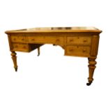 A Victorian birdseye maple partners kneehole library, writing table with tooled hide inset top