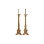 A large and impressive pair of gilt bronze altar-type candle stand lamps With urn sconces and fluted