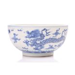 A Chinese porcelain dragon bowl, the interior and exterior painted with dragons amongst clouds,